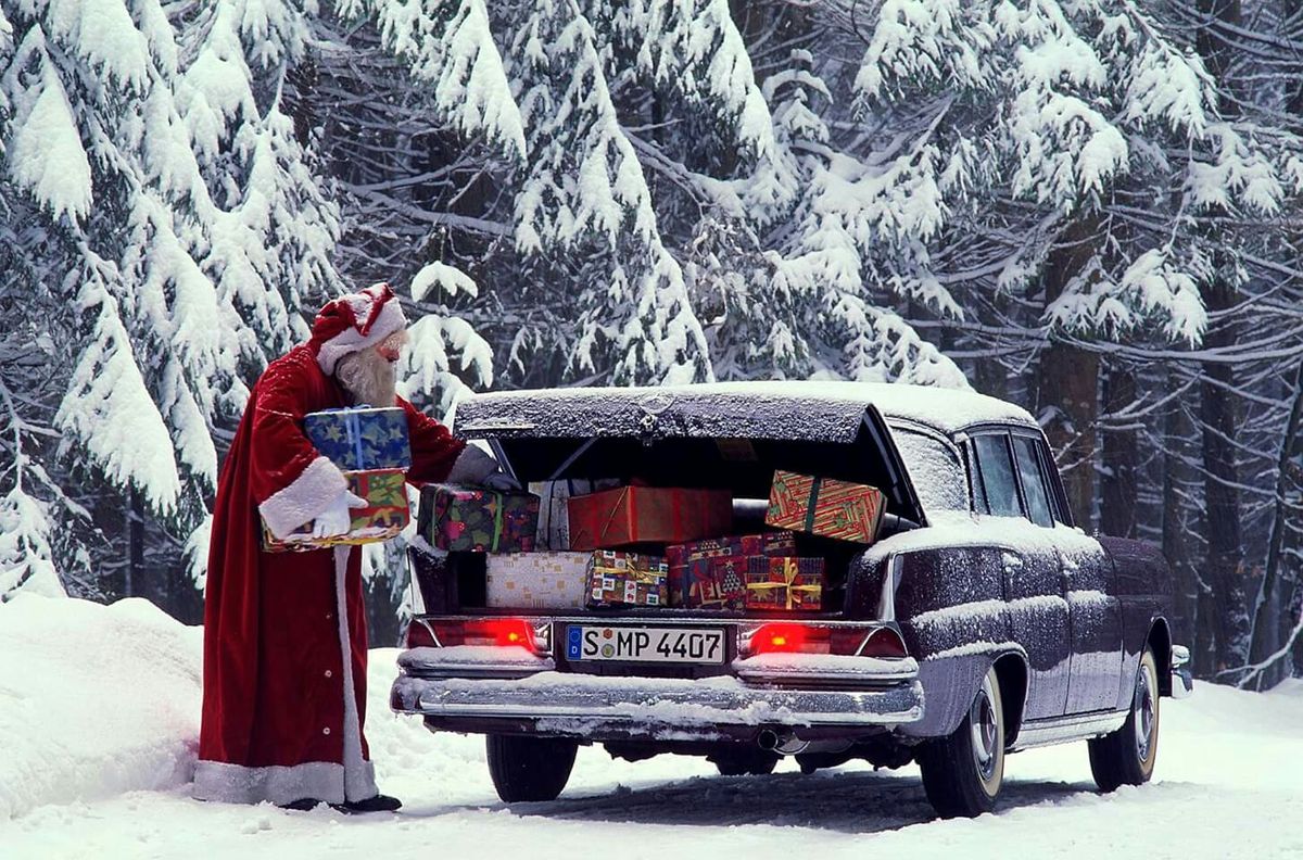 Santa filling up the boot of his Mercedes with presents